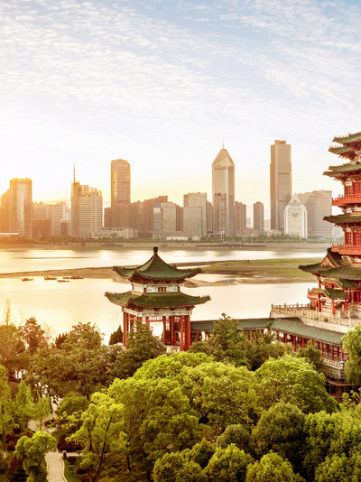 A skyline of an Asian city on the waterfront.
