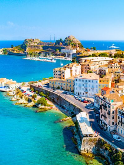An aerial view over a city and coastline in Corfu, Greece.