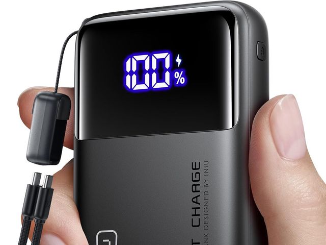 A hand holding an Iniu Portable Mini Power Bank showing 100% power left.