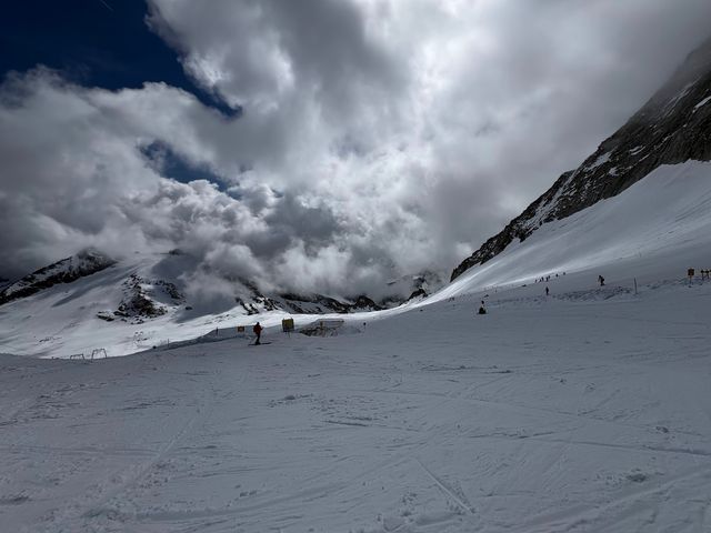 A snowy area of Hintertux Glacier surrounded by clouds in the sky.
