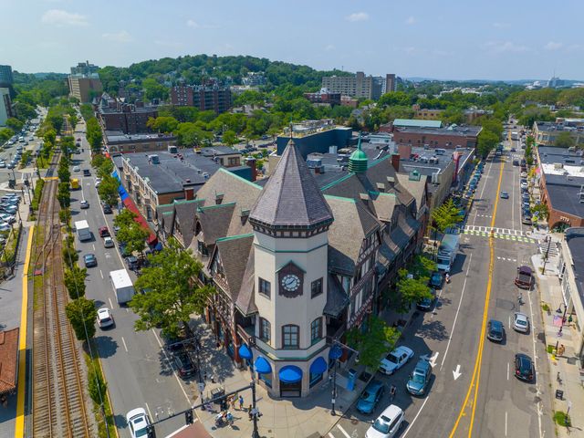 An aerial view of a historic commercial building on a corner in the city of Brookline, Massachusetts.