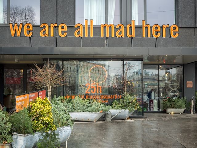 The entrance to the 25Hours Hotel in Vienna, Austria with a bold sign that says We Are All Mad Here.