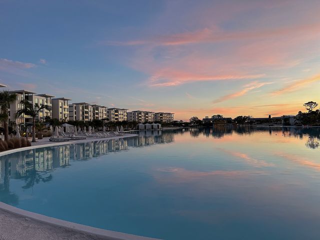 Hotel rooms face around a large body of water at Evermore Orlando Resort.