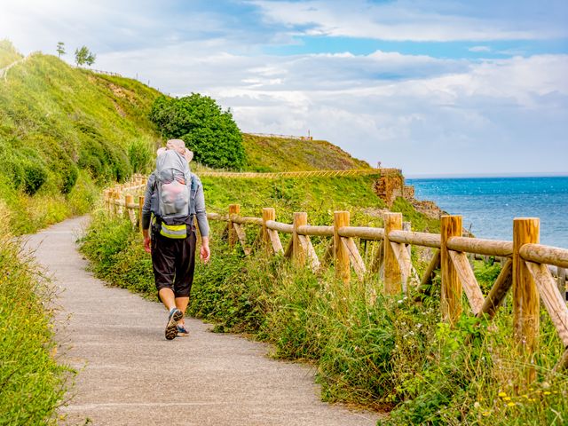 Pilgrim with backpack walking the Camino de Santiago in Spain, Way of St James.