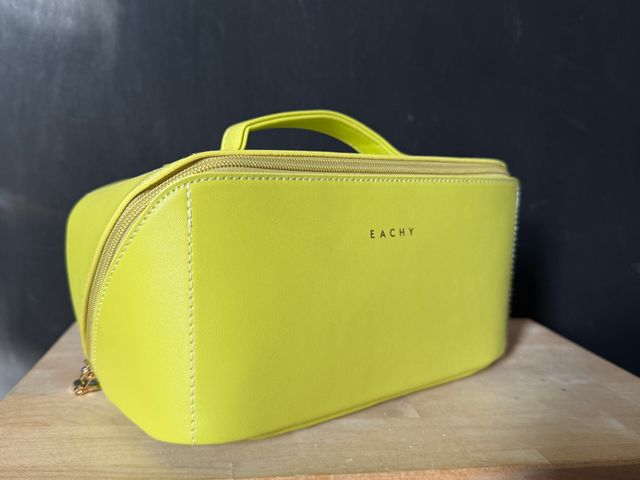 An Eachy Toiletry Bag in a lime green-yellow color.