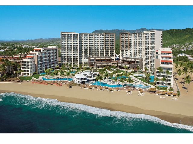 A view of Dreams Vallarta Bay Resort & Spa as seen from the ocean looking back at the beachfront property.