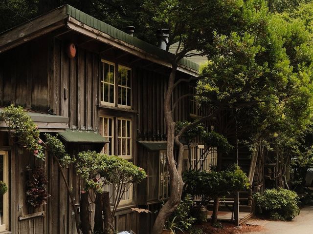 A wooden structure nearly hidden behind trees at Deetjen’s Big Sur Inn.