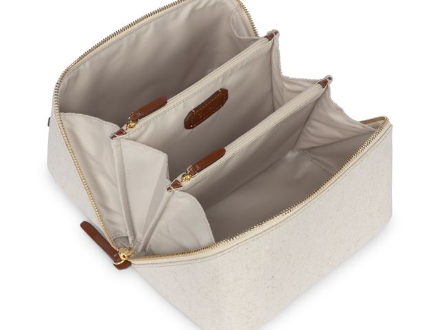 The Calpak Lay Flat Bag unzipped with internal sections visible.