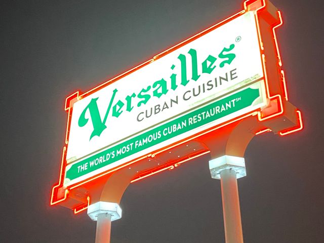 A neon sign lit up at night for Versailles Restaurant in Miami.