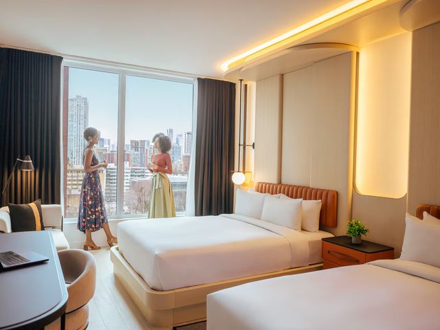 Two women standing at window in hotel room