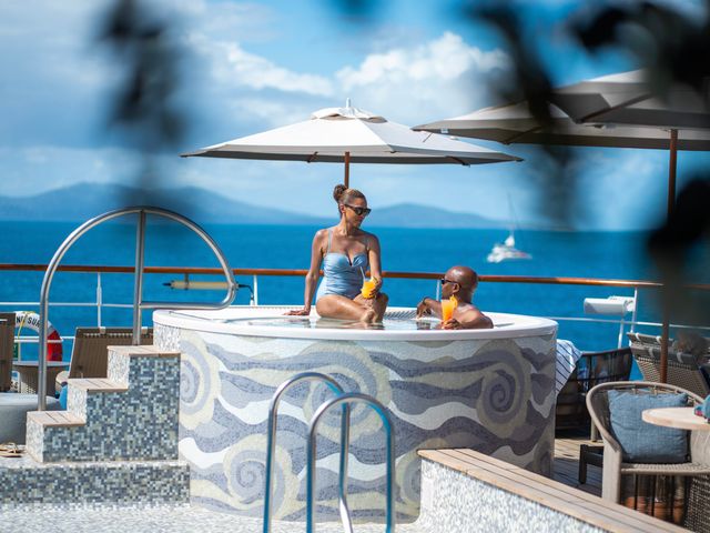 A couple is seen having drinks inside a hot tub on the deck of the Windstar Cruises' Wind Surf ship.
