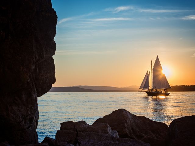 A sailboat is seen on Lake Champlain at sunset.