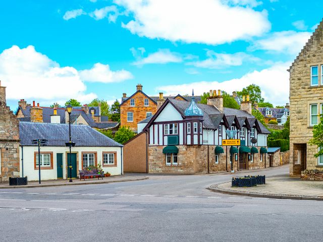 A town in Dornoch, Scotland with traditional brick and Tudor-style buildings.