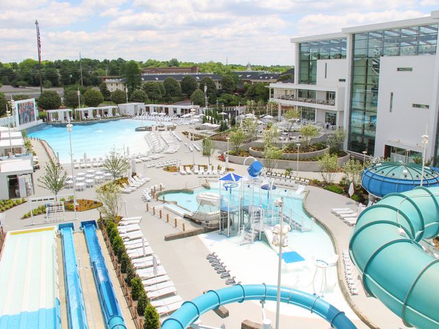 An outdoor pool deck at Gaylord Opryland Resort with water slides, splash pad, and zero-entry pool area.