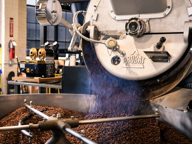 A coffee roasting machine processes coffee beans.
