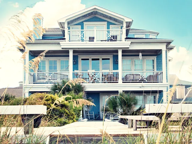 A beach house as seen from the front with multiple levels.