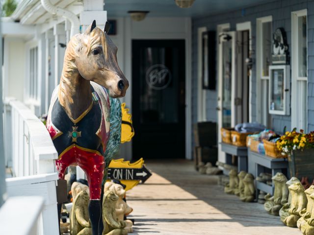 A horse sculpture on a shop porch. 