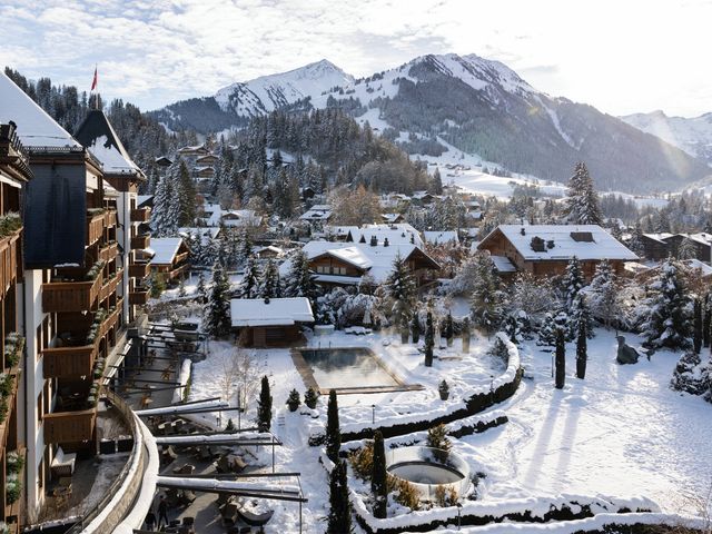 A resort blanketed in snow surrounded by mountains.