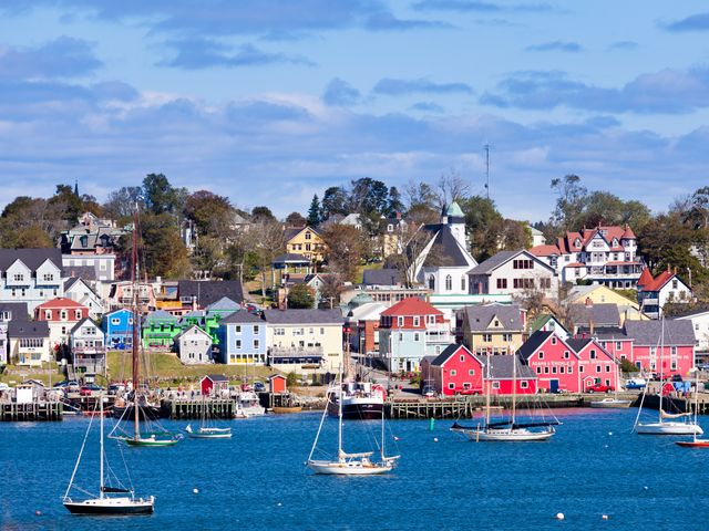 The historic harbor of Lunenburg with colorful buildings and boats in the water.