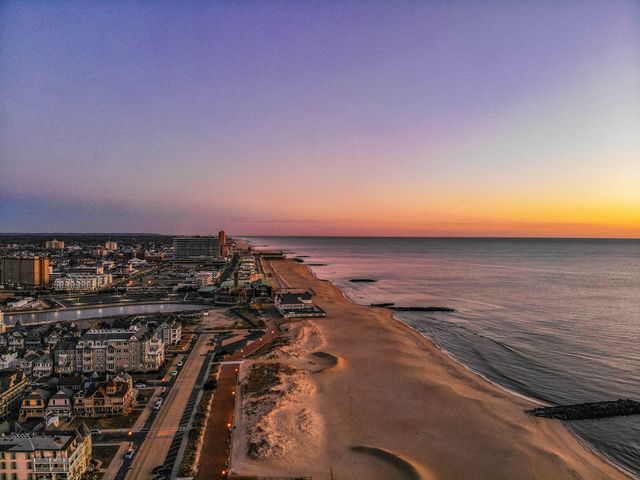 An aerial shot over the coast of Asbury Park, New Jersey at sunset.