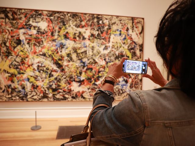 A visitor photographs an artwork inside the AKG Art Museum in Buffalo, NY