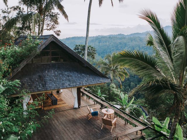 A villa with no walls tucked amid lush jungle foliage at Banyan Tree Escape in Bali.