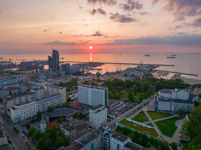 An aerial view over the city of Gdynia in Poland and its waterfront at sunrise.