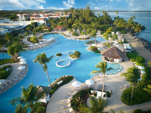 A sprawling lagoon-style pool next to the beach at the Hyatt Regency Grand Reserve Puerto Rico