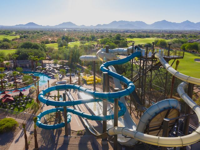 Swirling covered waterslides and pools next to golf course at the JW Marriott Phoenix Desert Ridge Resort & Spa.