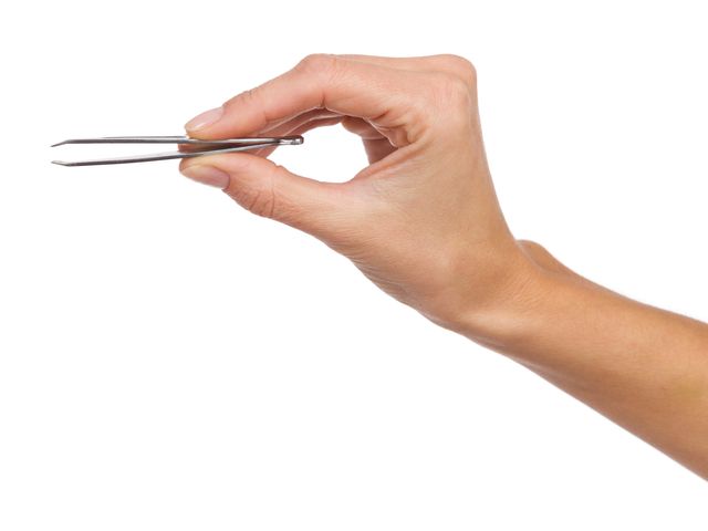 A hand is seen holding tweezers in a slightly pinched position.