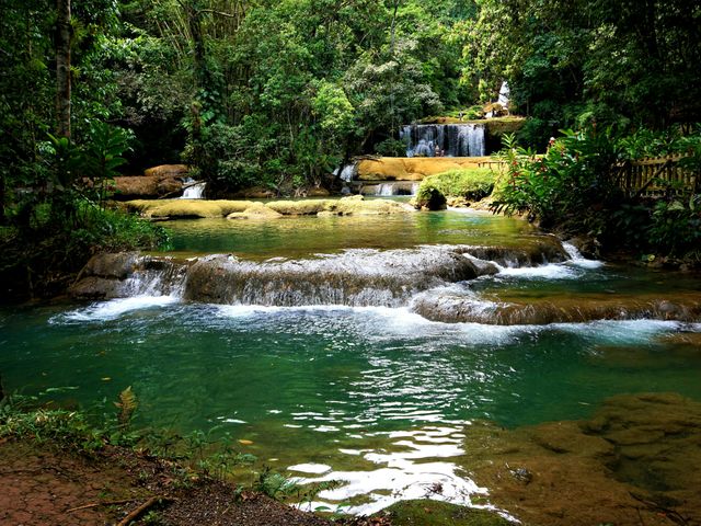 A series of tiered waterfalls surrounded by jungle foliage at YS Falls in Jamaica.