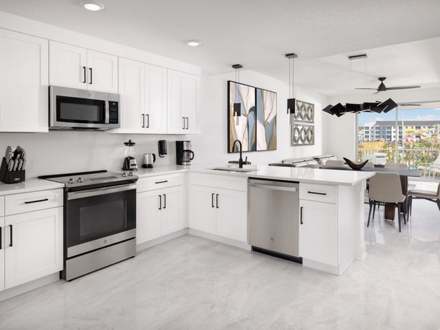 A white kitchen in a room at Villatel Orlando Resort.
