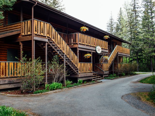 A timber lodge with ornate balcony details at Windsong Seward Lodge in Alaska.