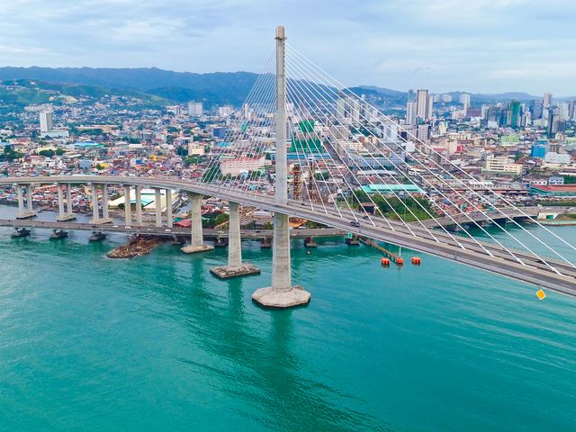 Aerial view of Cebu Cordova Link Expressway over blue waters in Cebu City, Philippines.