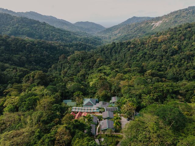 An aerial view of Asa Wright Nature Center tucked between lush trees in a remote location.