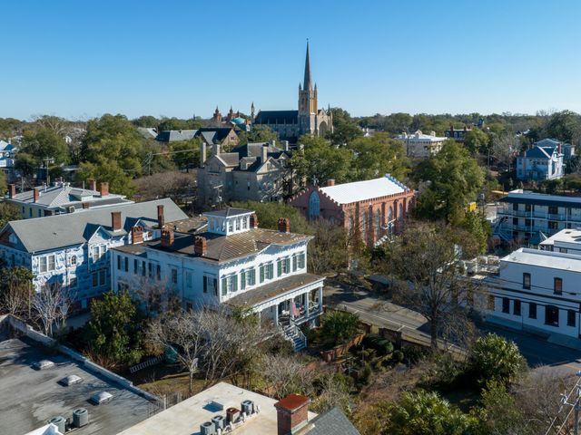 An aerial view over historic buildings and trees in downtown Wilmington.
