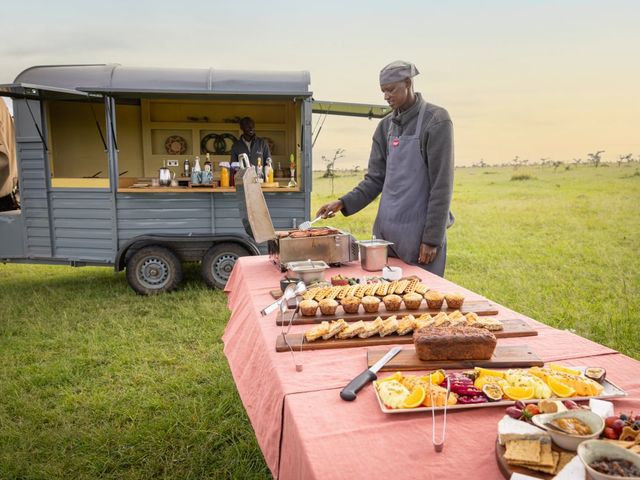 The table is set for a safari in the Naboisho Camp in an open-air setting.