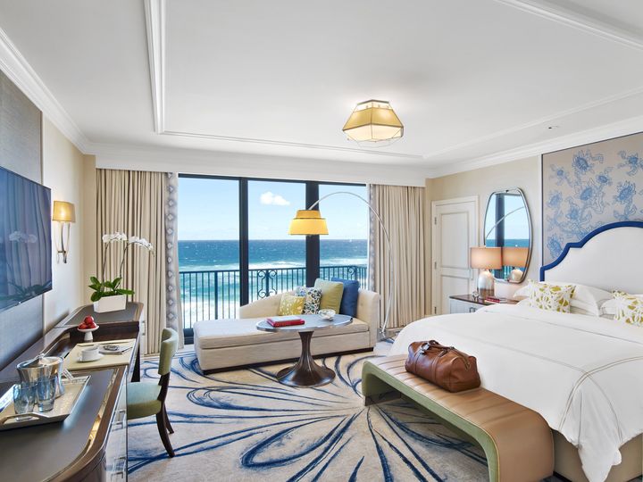 A stylish hotel room at The Breakers Palm Beach with views of the ocean.