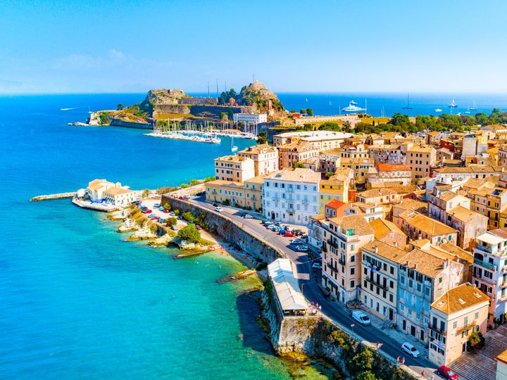 An aerial view over a city and coastline in Corfu, Greece.