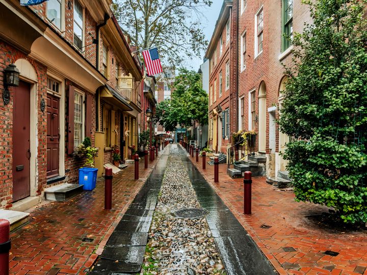 The historic Elfreth's Alley in Philadelphia lined with brick buildings.