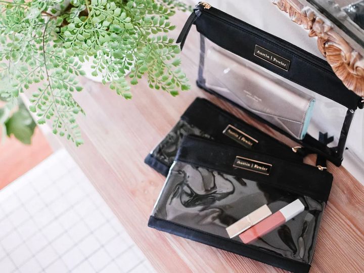The Everyday Packing Totes from Austin Fowler on a table next to a green plant.
