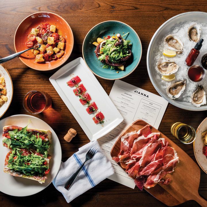 An overhead shot of a table artfully posed with plates of food.