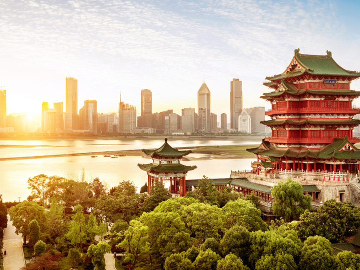 A skyline of an Asian city on the waterfront.