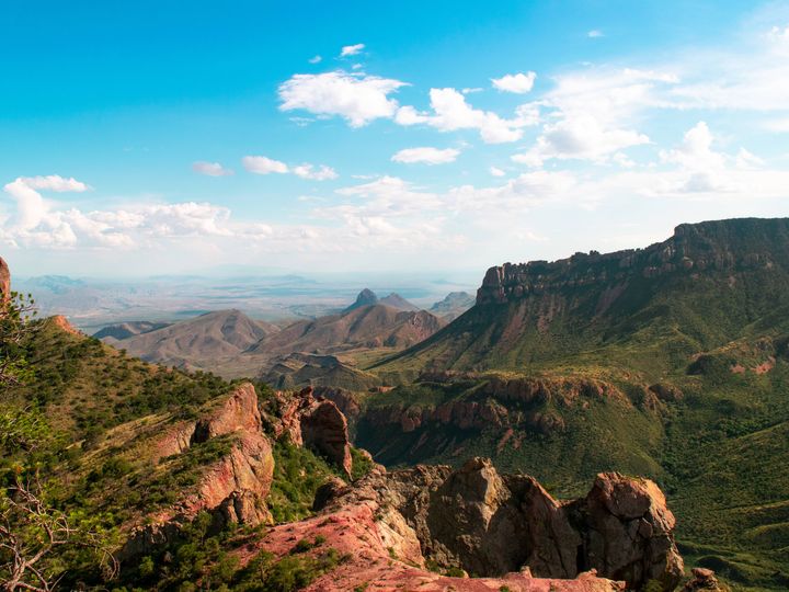 A scenic panoramic view over Big Bend National Park with canyons and trees from Lost Mine Trail.