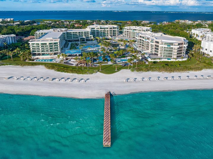 An aerial view of The St. Regis Longboat Key Resort as seen from the beach and water.