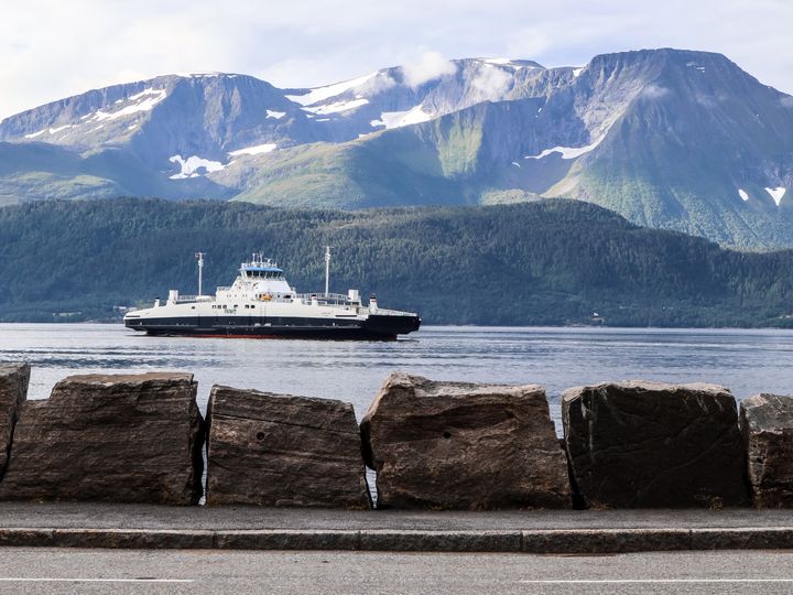 A ferry is seen sailing over the water from Magerholm to Sykkylven in Norway.