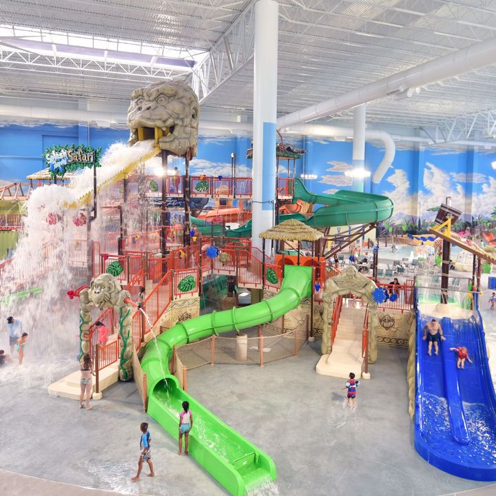 An elaborate indoor water park with a play structure, water slides, and interactive water features at Kalahari Resort Round Rock.