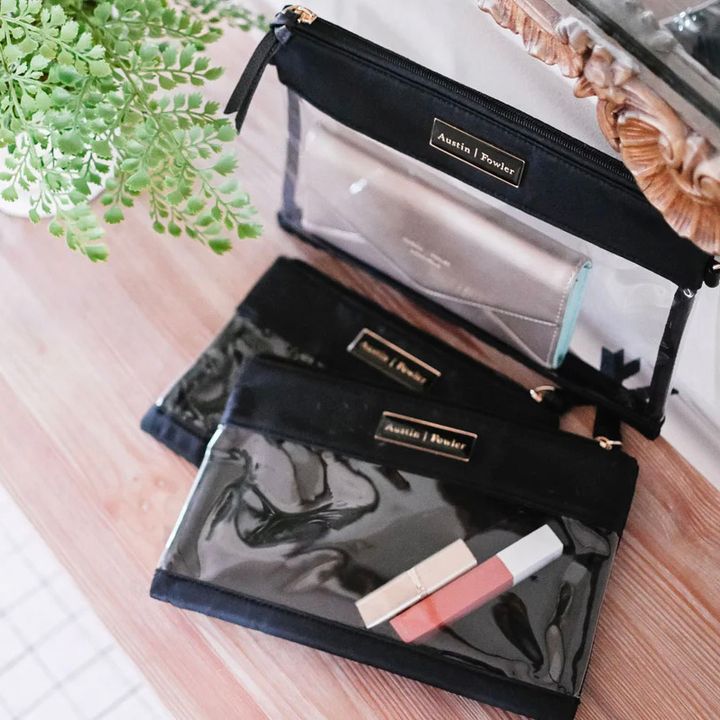 The Everyday Packing Totes from Austin Fowler on a table next to a green plant.
