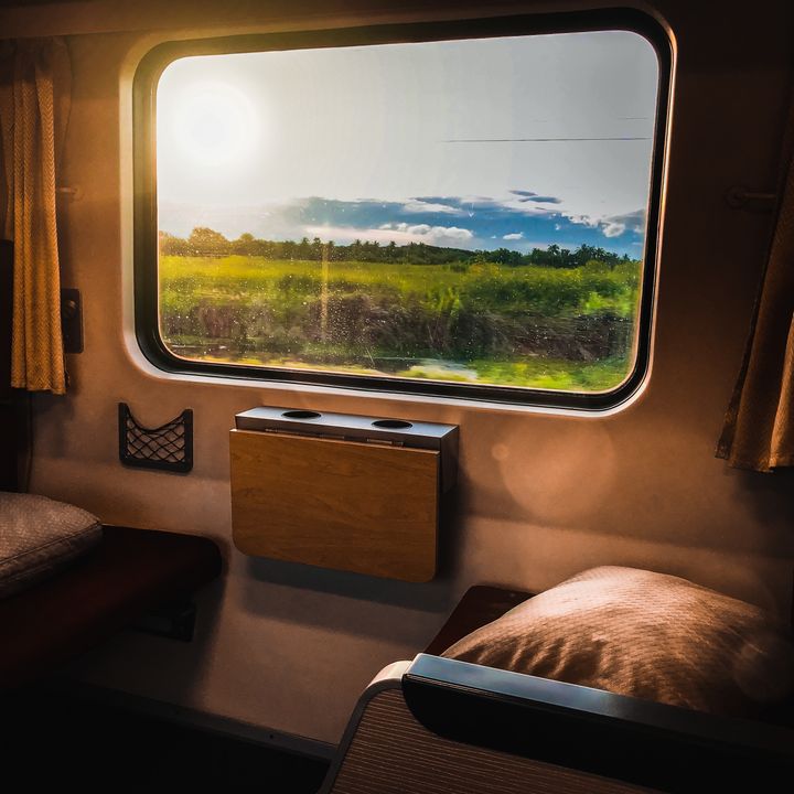 A scenic view outside of a train car window.