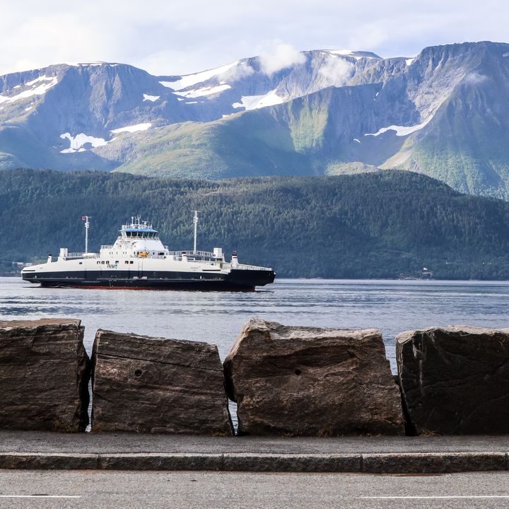 A ferry is seen sailing over the water from Magerholm to Sykkylven in Norway.